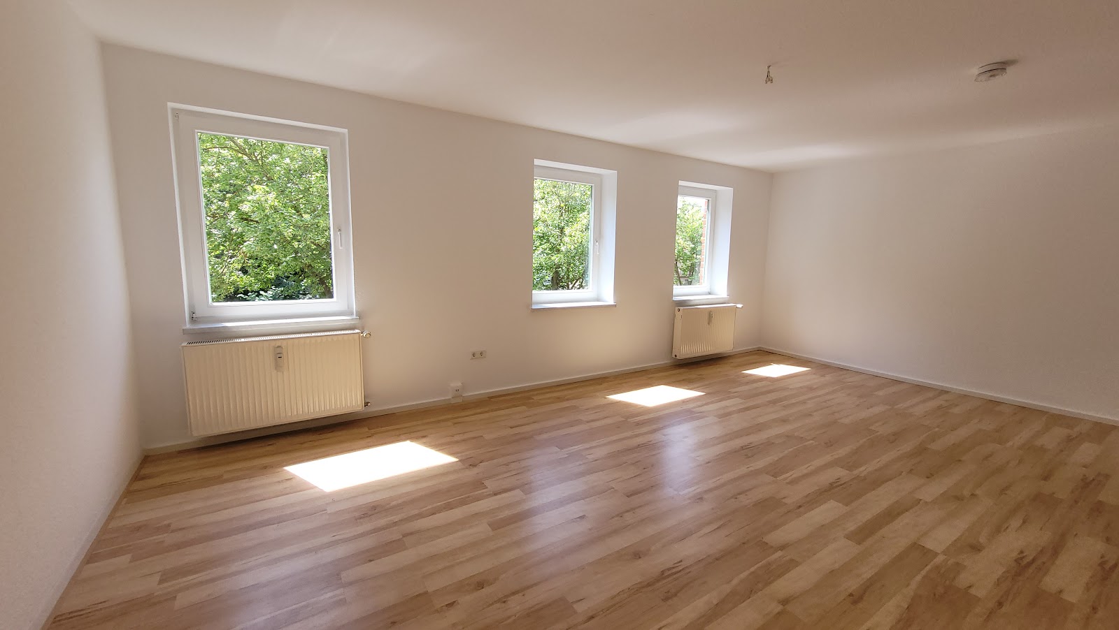 Einblick Wohnzimmer mit offener Küche